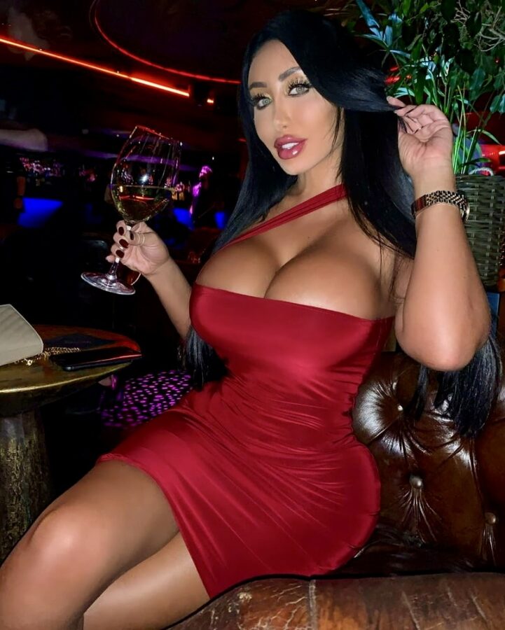 Classy party babe exposing large cleavage at night club