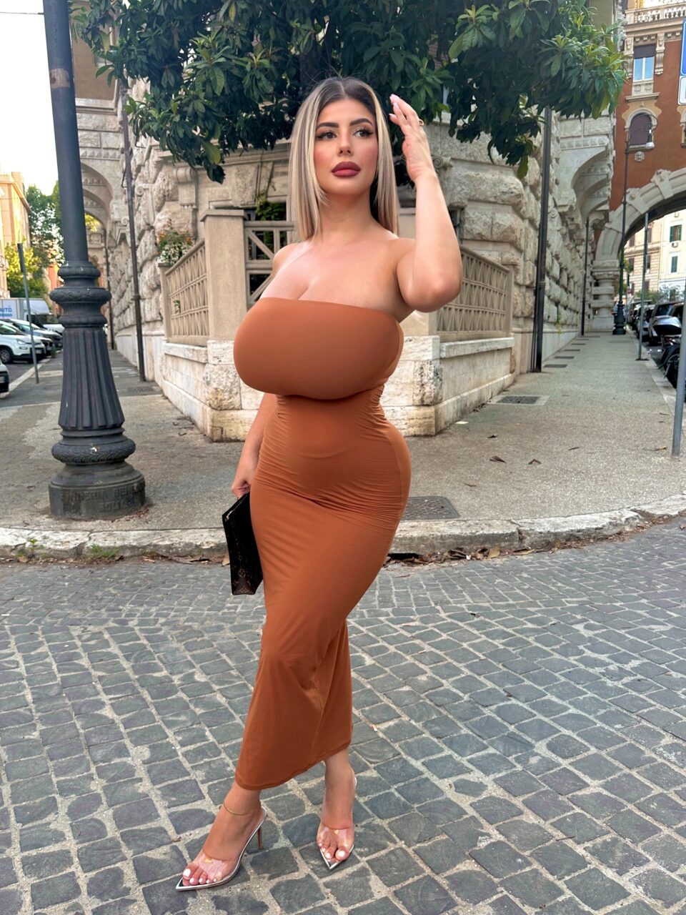Italian busty model on public street exposing massive melons in tight sexy dress